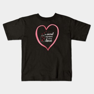 The secret ingredient is Love with a large heart Kids T-Shirt